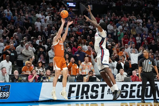 Camden Heide #5 of the Texas Longhorns attempts a shot while being guarded by Tyon Grant-Foster #7 of the Gonzaga Bulldogs during the second half in the second round of the 2026 NCAA Men's Basketball Tournament at Moda Center on March 21, 2026 in Portland, Oregon. (Photo by Soobum Im/Getty Images)