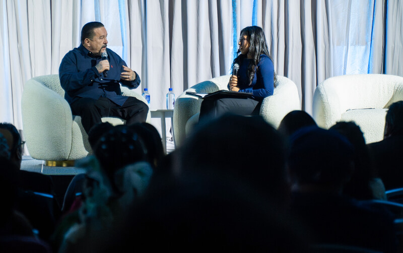 A CSUF student interviews Mister Cartoon on stage in the Titan Student Union Portola Pavilion 