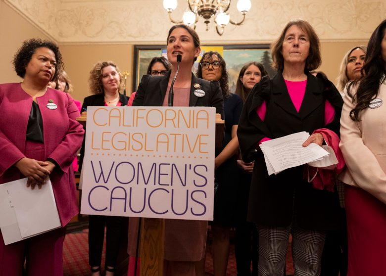 Women at a podium with a "California Legislative Women's Caucus" sign.