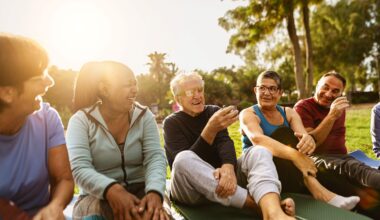 Diverse group of seniors sitting outdoors, drinking tea after exercising