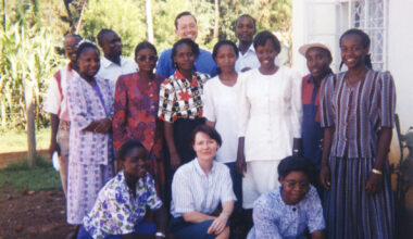 Ted Miguel poses in a group photo in 1998 with about a dozen NGO members working on the deworming project in Busia, Kenya