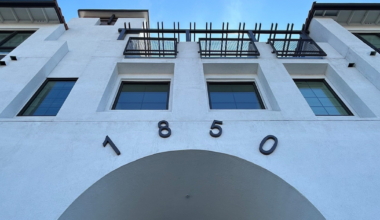 A white building with black-framed windows features the number "1850" above an archway labeled "VILLABELLA" in metal letters.