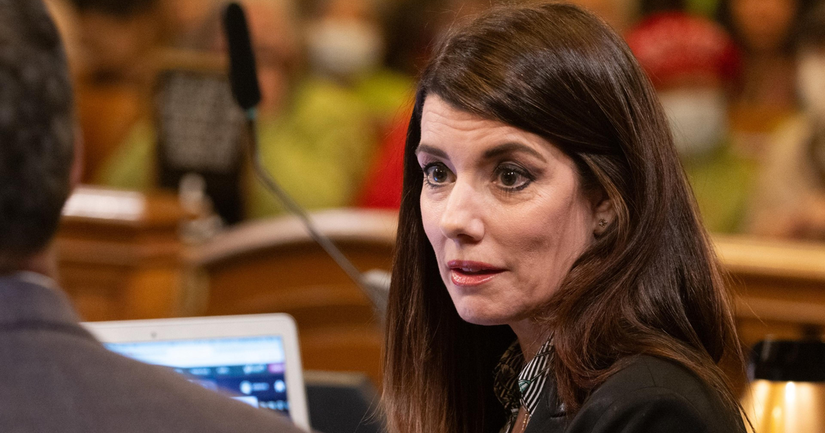 Supervisor Catherine Stefani in her chair talks with another Board of Supervisor during public comment at city hall.