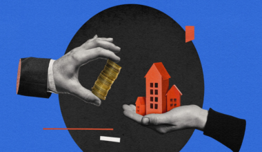 One hand holds a stack of gold coins, while another hand holds three red house models, symbolizing real estate investment or property purchase.