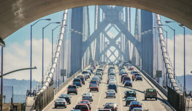Cars stuck in gridlock traffic on a bridge.