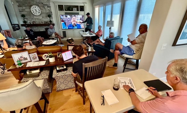 Auctioneer Steve Martin (top) calls teams during Calcutta auction on the eve of the NCAA Tournament. (Kirk Kenney / San Diego Union-Tribune)