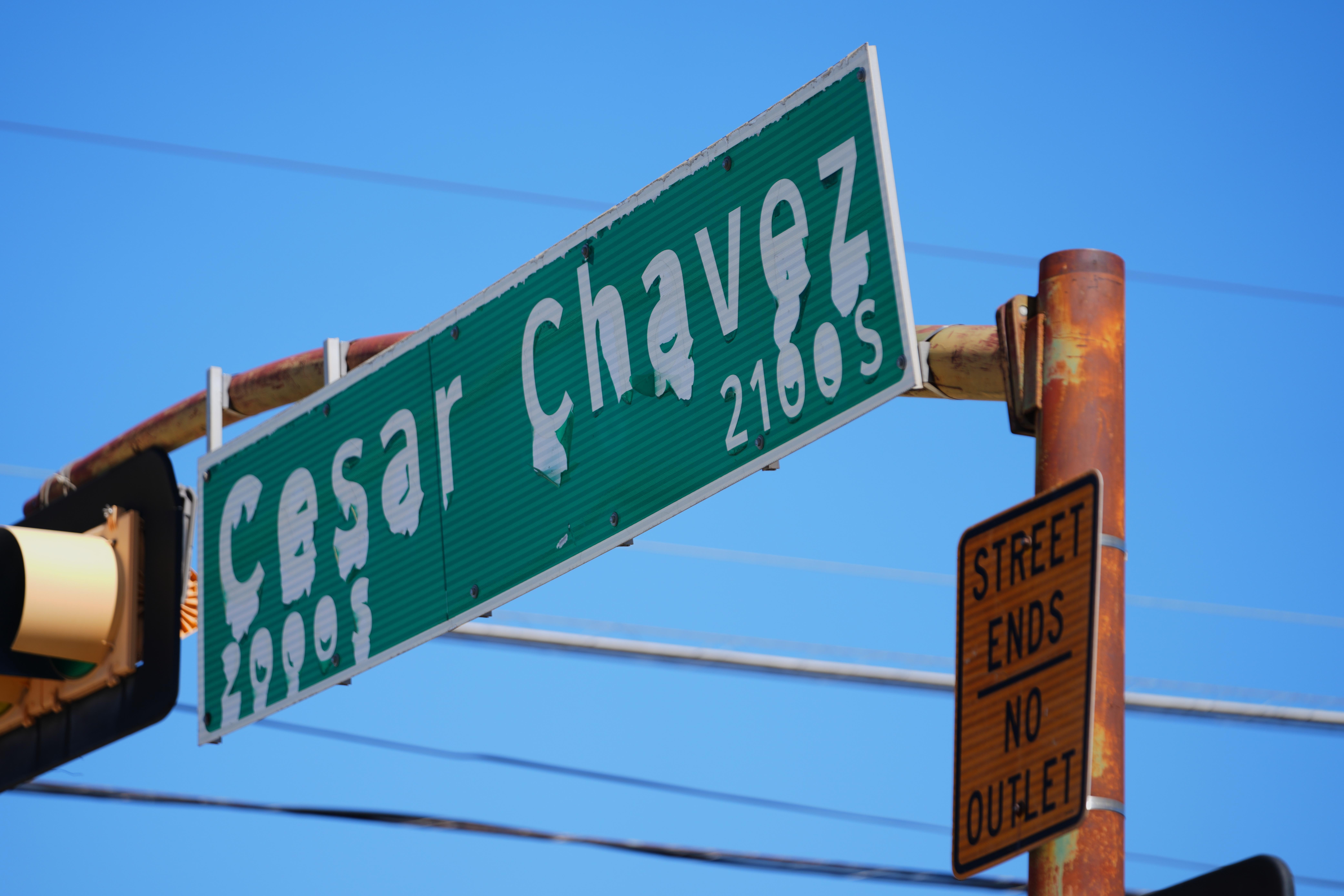 A worn sign identifies Cesar Chavez Boulevard in Dallas, Thursday,...