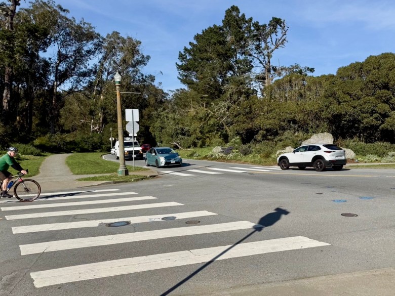 Traffic intersection with cyclist waiting in the wings