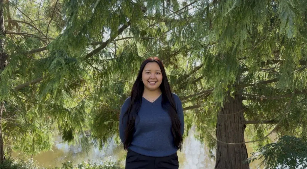 Woman stands in trees