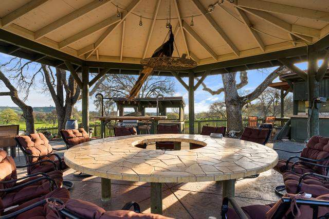 At the tabletop pavilion, property owner Brian Kraft said friends once stayed up under kerosene lanterns around the round stone table, using the outdoor setup for barbecues before the property had power.