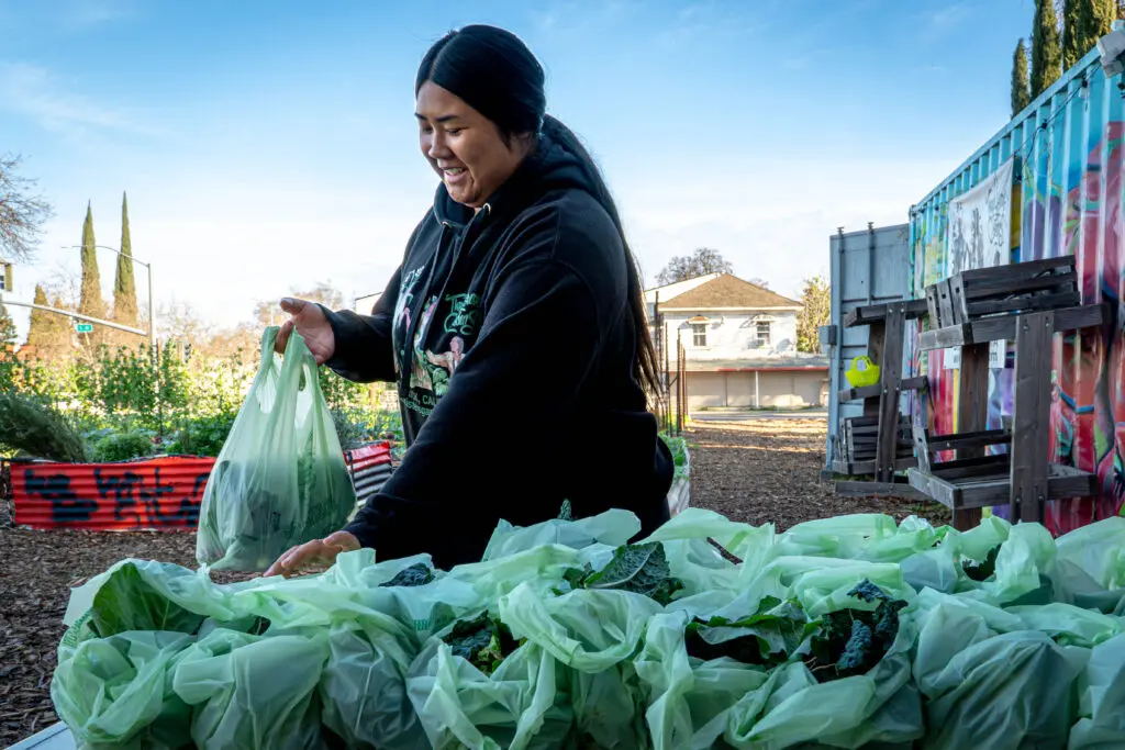Woman placing vegetable bags on table