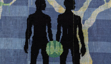 two black silhouettes' hands touch and green glow forms