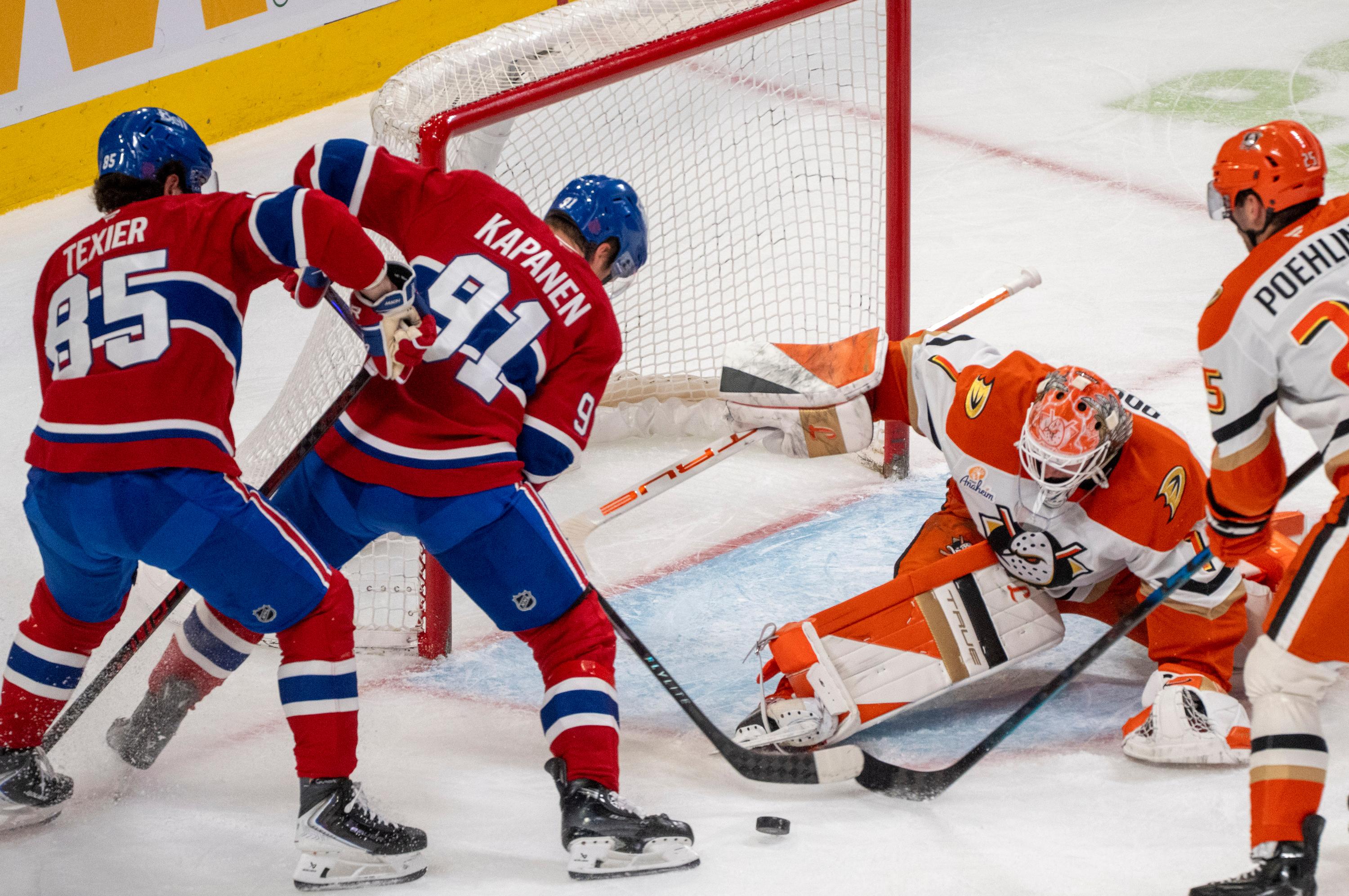 Ducks goaltender Lukas Dostal, second from right, stops a shot...