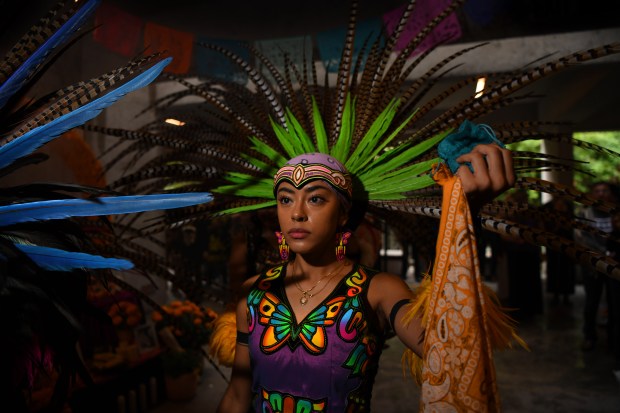 Liliana Bernardo with the Ollin Anahuac Traditional Aztec Dance Group performs a dance during the 29th annual Dia De Los Muertos Celebration at the Oakland Museum of California in Oakland, Calif., on Sunday, Oct. 22, 2023. Because of the weather many of the performances that were planned outside were moved inside. (Jose Carlos Fajardo/Bay Area News Group)