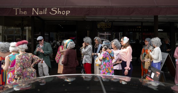 A line of granny's makes their way to the registration table on Park Street during the 2nd Annual GrannyCon in Alameda, Calif., Saturday, March 07, 2026. The lighthearted event is a fundraiser for breast cancer research, education and legislation and was formed by a group of moms during the Coronavirus Pandemic of 2020. (Douglas Despres / for the Bay Area News Group)
