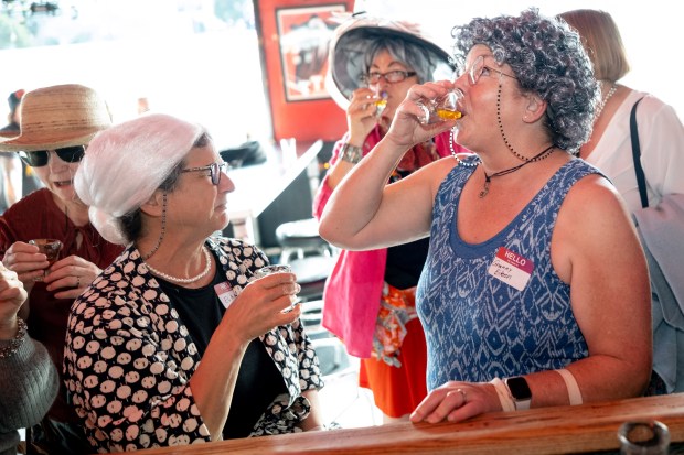 Granny Eileen (right) and friends drink a "Granny's Apple Pie" shot inside the Lucky 13 bar on Park Street during the 2nd Annual GrannyCon in Alameda, Calif., Saturday, March 07, 2026. The lighthearted event is a fundraiser for breast cancer research, education and legislation. It was formed by a group of moms during the Coronavirus Pandemic of 2020. (Douglas Despres / for the Bay Area News Group)