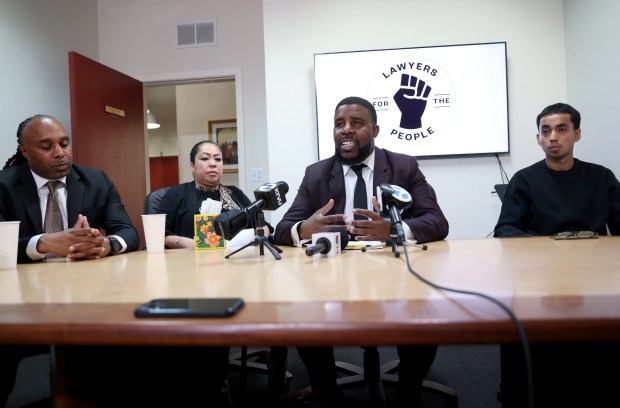 Attorney Adanté Pointer speaks during a press conference at the Lawyers for the People office in Oakland, Calif., on Tuesday, March 17, 2026. To the right is Imer Mendez, son of Jose De Jesus Mendez, and to the left is Rosa Hernandez, wife of Mendez. Far left is attorney Marlon Monroe. Mendez was shot and killed by Richmond police on Feb. 4, 2025 after holding a knife sheath. (Jane Tyska/Bay Area News Group)