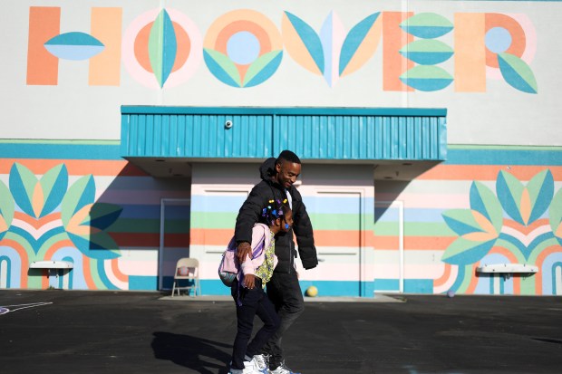 Hoover Elementary School parent Justin Sheffield walks his daughter Kimircle to her second grade class room for the first day of instruction on Monday, Aug. 8, 2023, in Oakland, Calif. (Aric Crabb/Bay Area News Group)