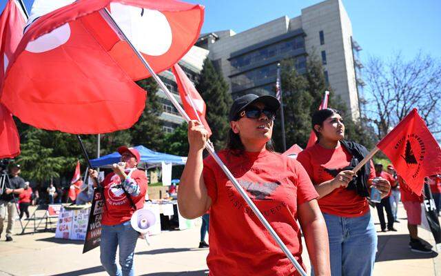 Protesters rally outside the Robert E. Coyle Federal Courthouse to voice opposition to a proposed change in pay for guest workers Wednesday, March 18, 2026 in downtown Fresno.