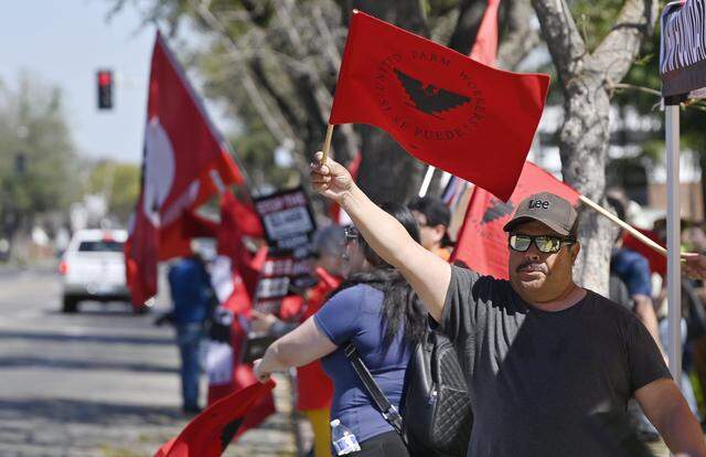 Protesters rally outside the Robert E. Coyle Federal Courthouse to voice opposition to a proposed change in pay for guest workers, Wednesday, March 18, 2026 in downtown Fresno.