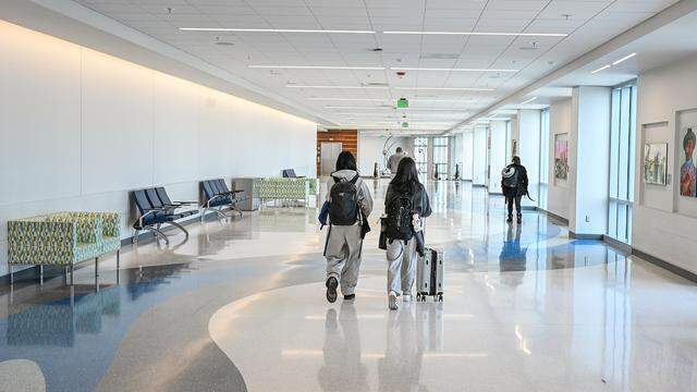 Passengers walk through the Concourse B gallery, part of Fresno Yosemite International's $150 million terminal expansion project, on Tuesday, Jan. 13, 2026.
