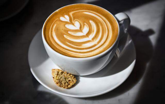 A latte is prepared with a piece of biscotti at Il Caffè, a cafe within Enzo's Table at Willow and Shepherd in northwest Clovis serving traditional Italian espresso drinks, coffee and baked goods. 
