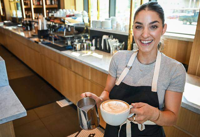 Kylie Adanalian smiles after preparing an espresso drink at Il Caffè, a cafe within Enzo's Table at Willow and Shepherd in northwest Clovis.