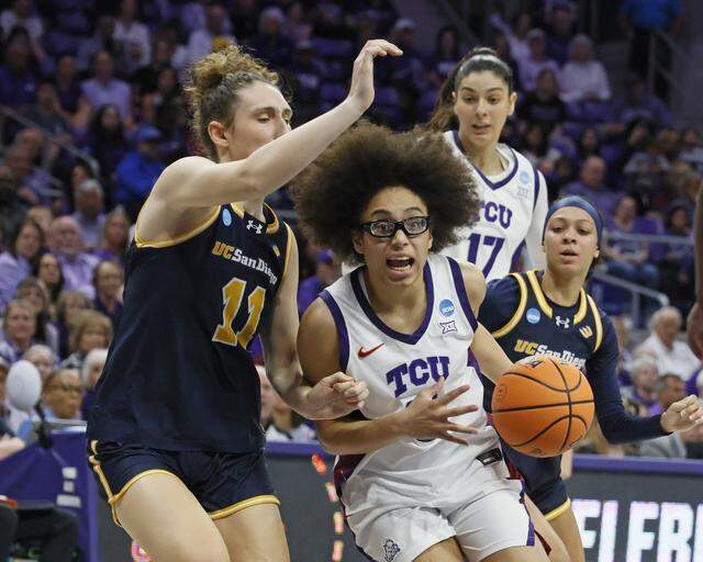 TCU guard Olivia Miles (5) drives against UC San Diego center Erin Condron (11) during the first half of an NCAA Division I Women's Basketball Championship game at Schollmeier Arena in Fort Worth, Texas, Friday, March, 20, 2026.