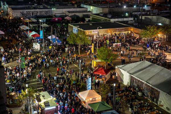 Aerial view of thousands of people at outdoor event in a downtown Fresno beer garden and surrounding area