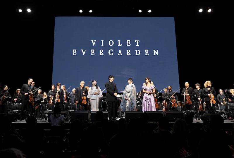 Orchestra standing before a crowd