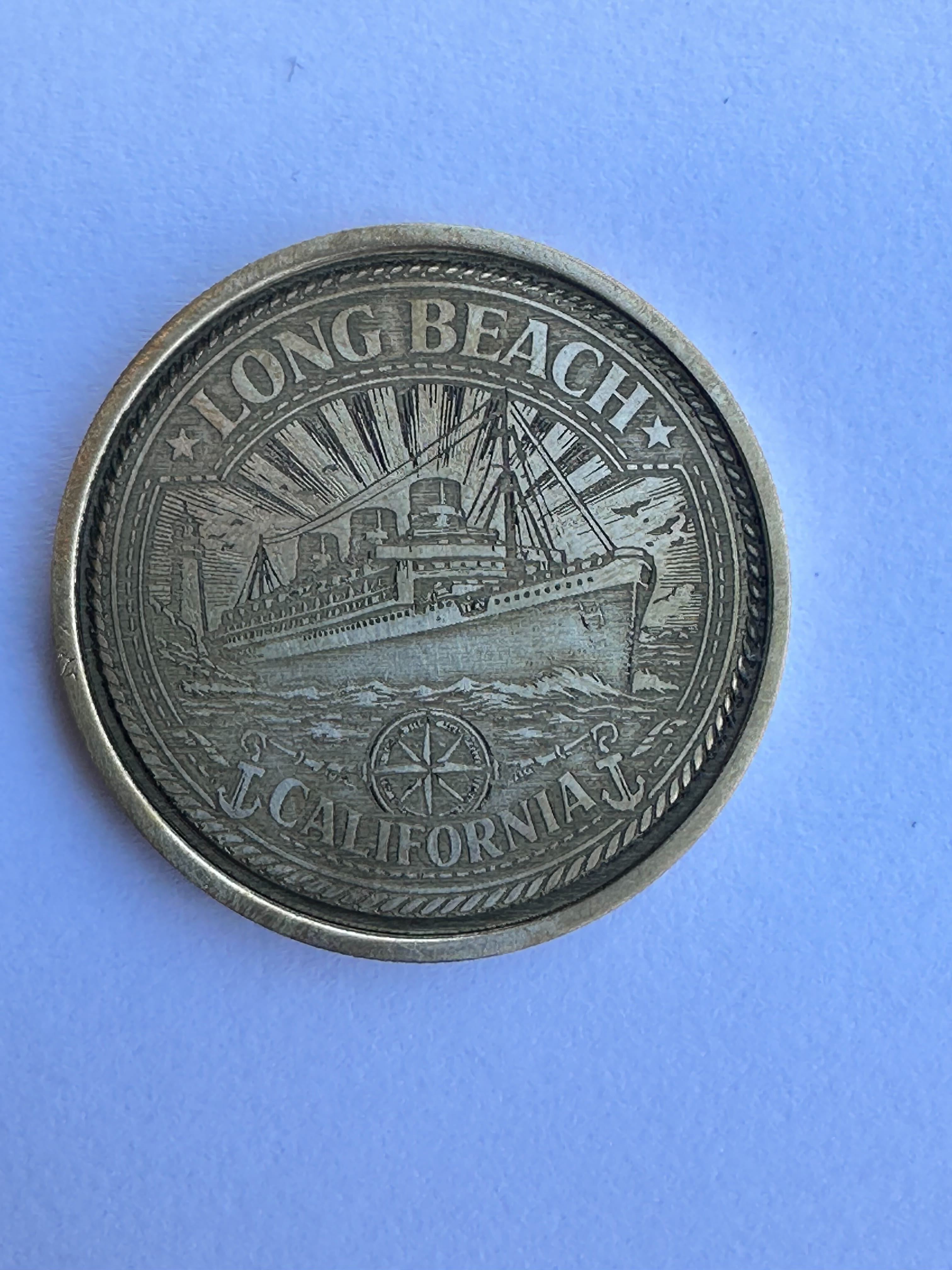 A keepsake coin, featuring the Queen Mary, for sale at...