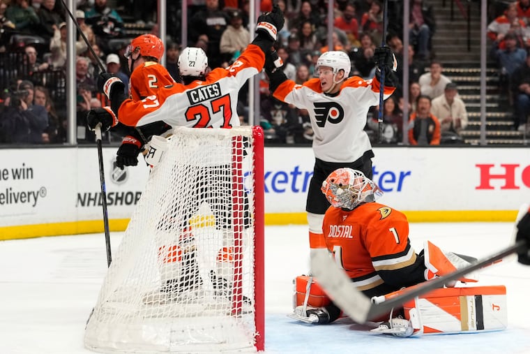Flyers wing Noah Cates (left) celebrates his game-winning goal with Matvei Michkov against the Ducks in overtime.
