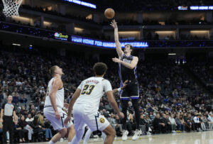 SACRAMENTO, CALIFORNIA - DECEMBER 11: Maxime Raynaud #42 of the Sacramento Kings shoots over Bruce Brown #11 and Nikola Jokic #15 of the Denver Nuggets in the second half at Golden 1 Center on December 11, 2025 in Sacramento, California. NOTE TO USER: User expressly acknowledges and agrees that, by downloading and or using this photograph, User is consenting to the terms and conditions of the Getty Images License Agreement. (Photo by Thearon W. Henderson/Getty Images)