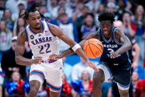 LAWRENCE, KANSAS - JANUARY 31: Darryn Peterson #22 of the Kansas Jayhawks and forward AJ Dybantsa #3 of the BYU Cougars chase down a loose ball in the first half at Allen Fieldhouse on January 31, 2026 in Lawrence, Kansas. (Photo by Ed Zurga/Getty Images)
