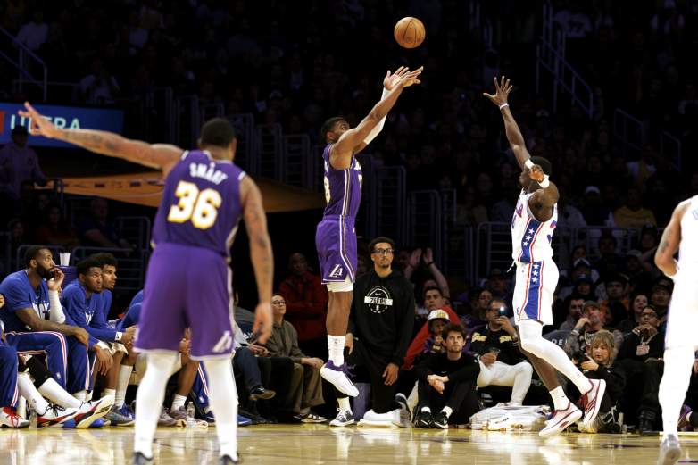 Los Angeles Lakers guard Marcus Smart gestures a three with his fingers as Los Angeles Lakers forward Rui Hachimura sinks a three.