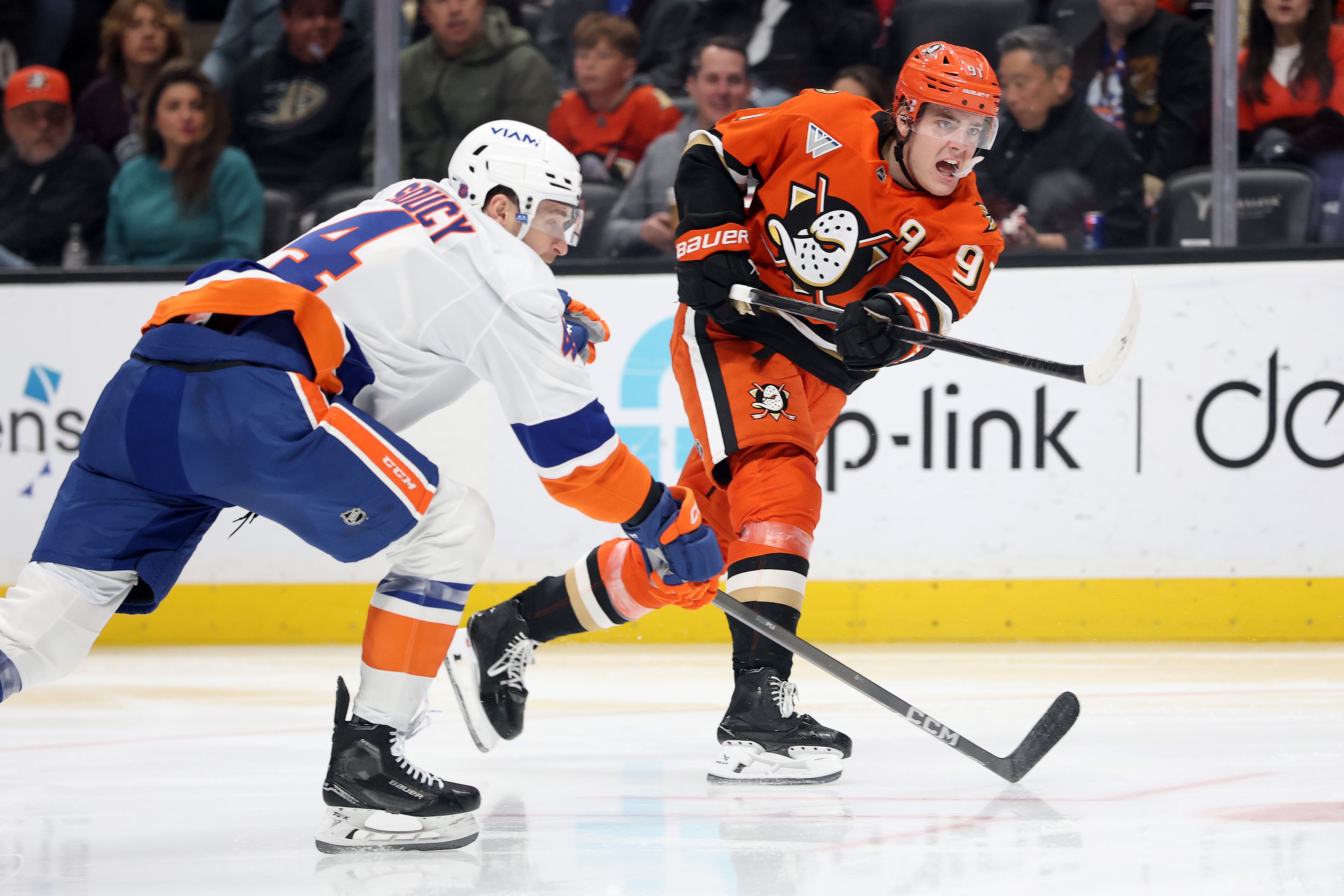 The Ducks’ Leo Carlsson, right, shoots the puck as the...