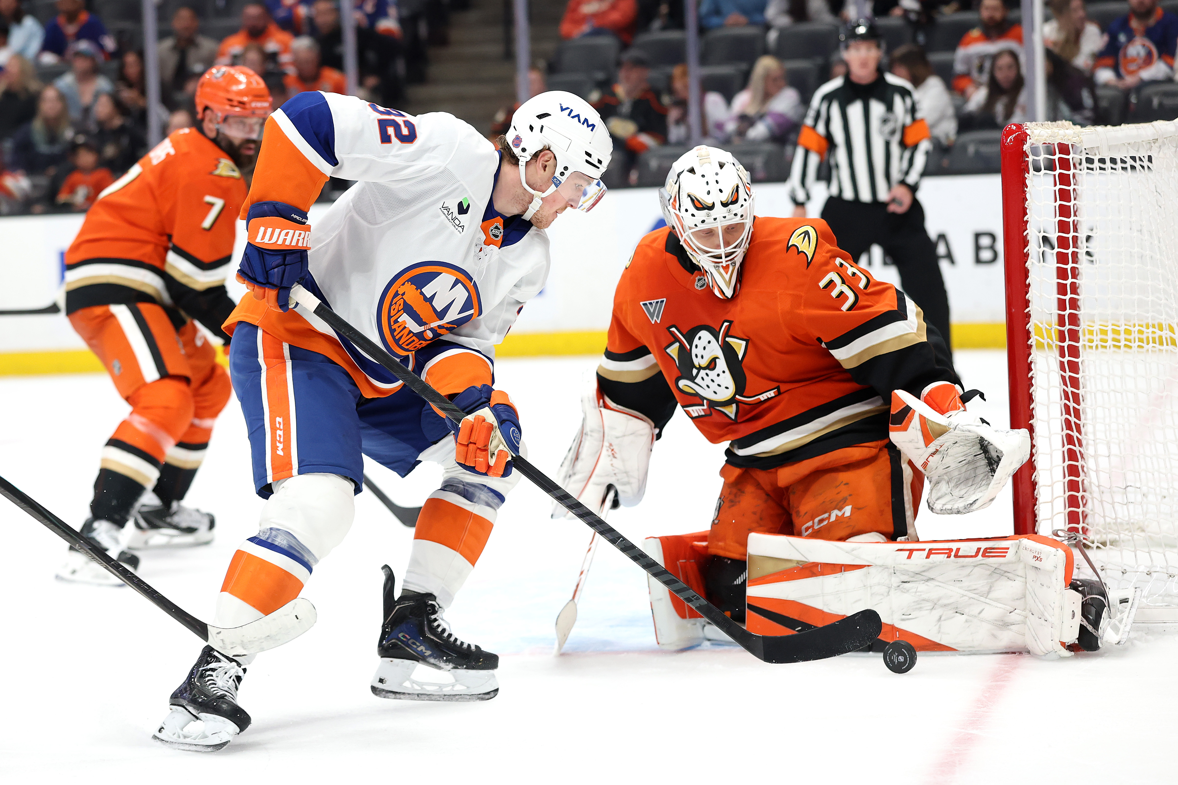 The New York Islanders’ Kyle MacLean, left, pokes at a...