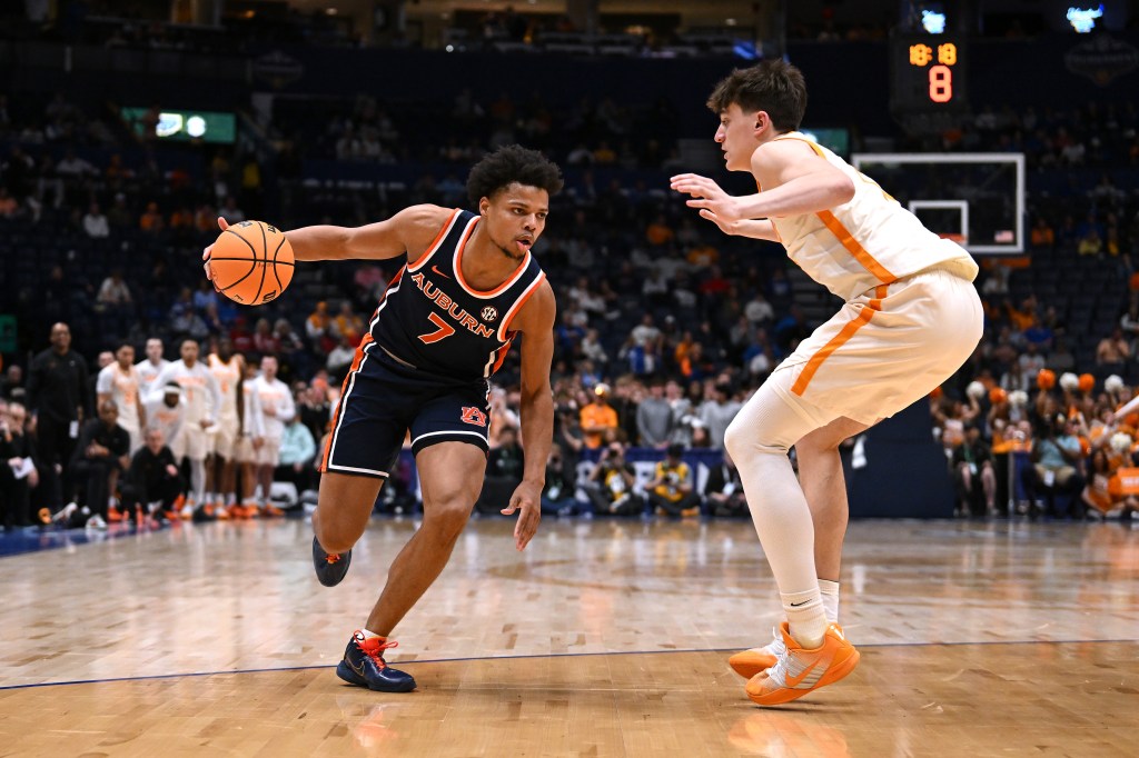 Keyshawn Hall #7 of the Auburn Tigers drives to the basket against J.P. Estrella #13 of the Tennessee Volunteers during the SEC Tournament on March 12, 2026.