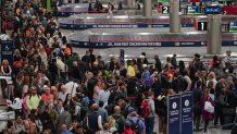 Travelers wait in line at a TSA checkpoint at Hartsfield-Jackson Atlanta International Airport in Atlanta, Georgia on Friday, March 20, 2026. Travelers have encountered long lines snaking through terminals during the partial government shutdown, prompting airports to warn passengers to show up hours before their flight. 