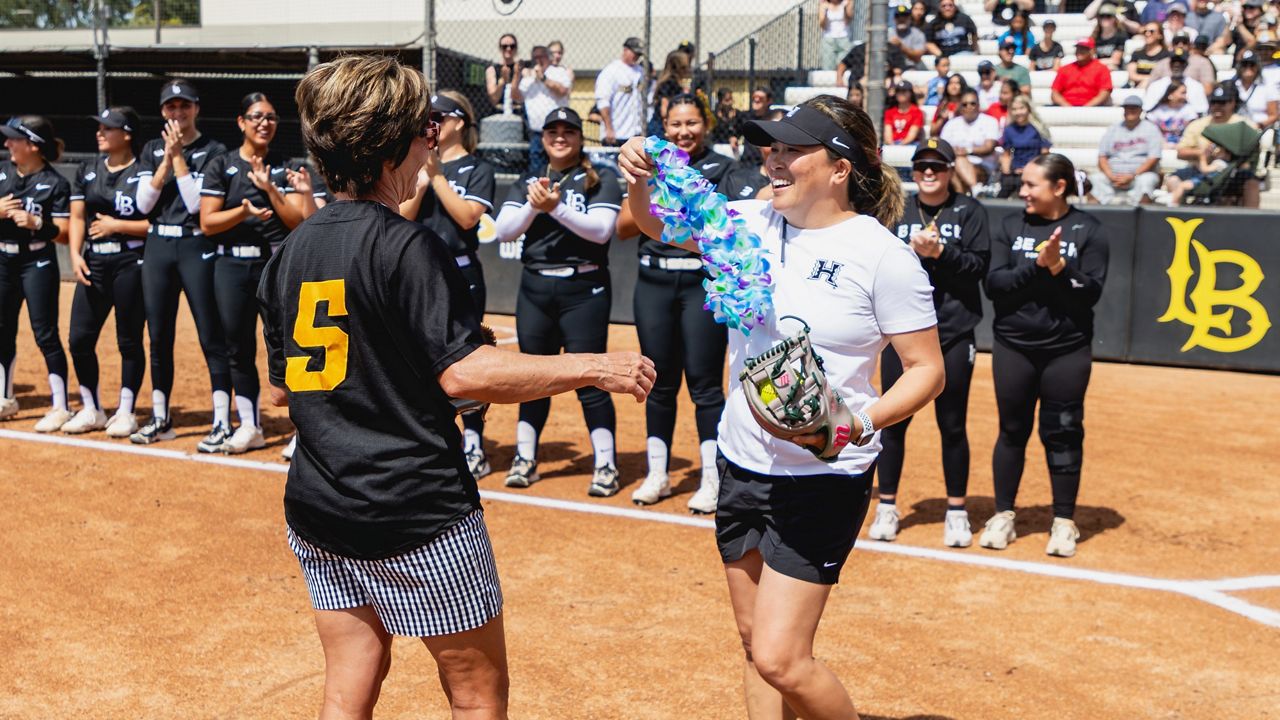 Hawaii softball coach Panita Thanatharn presented her mentor, recently retired Long Beach State coach Kim Sowder, a lei during a first pitch ceremony at the LBSU Softball Complex on Saturday.