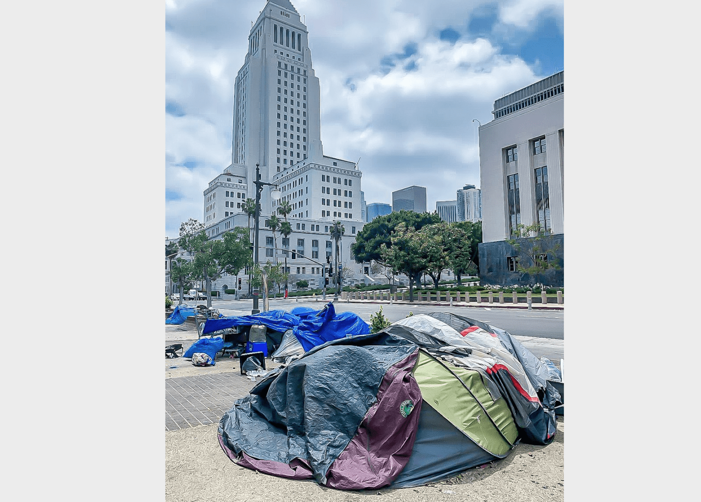 Los Angeles City Hall looms over a nearby homeless encampment.