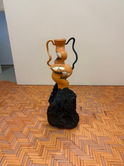 Ceramic amphora sculpture on cracked tile floor in Cammie Staros Pompeii