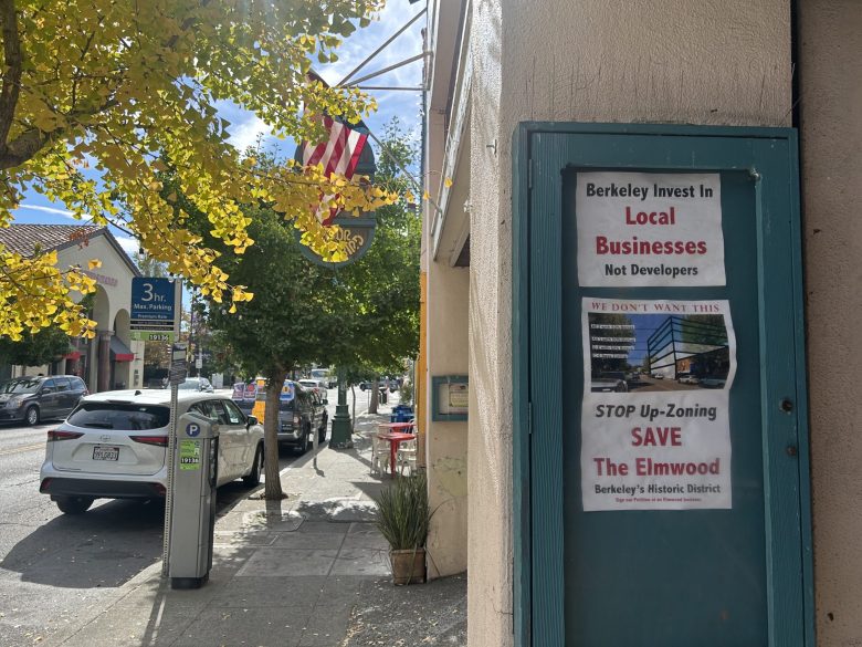 A sign reads, "stop up-zoning, save the Elmwood" and "we don't want this" with a rendering of a mid-rise apartment building