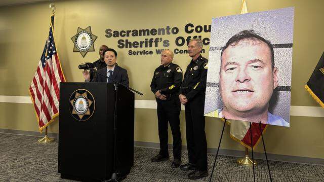 Sacramento County District Attorney Thien Ho, center, speaks during a news conference on Thursday, March 12, 2026, at the Sacramento County Sheriff’s Headquarters in Old Foothill Farms. Ho joined, from left, Sheriff Jim Cooper, Assistant Sheriff Salvador Robles and Undersheriff Mike Ziegler to call for reform to California’s Elderly Parole Program in response to the planned release of Gregory Vogelsang, pictured on the poster.