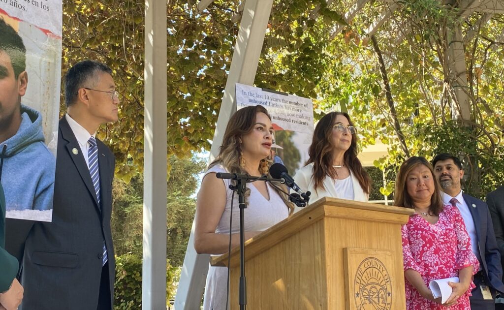 A woman speaks at a podium outside in San Jose, California