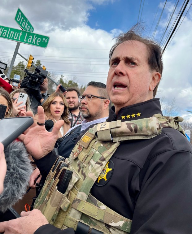 Oakland County Sheriff Mike Bouchard at the scene Thursday, along side West Bloomfield Police Chief Dale Young. (Peg McNichol / MediaNews Group)