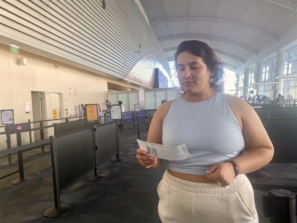 Woman looking at plane ticket