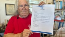 Susan Johnson with the South Bayfront Sailing Association, holds the lease termination letter ordering her non-profit organization out of the harbor, Chula Vista, Calif., March 21, 2026.