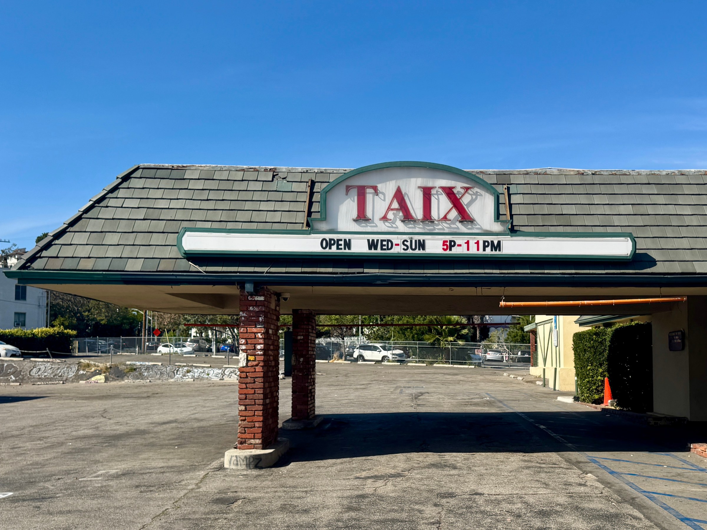 Taix during the daytime with an overhand over a parkway.