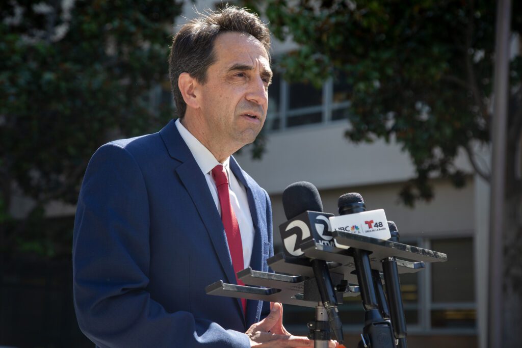 Santa Clara County District Attorney Jeff Rosen speaks outside at a podium